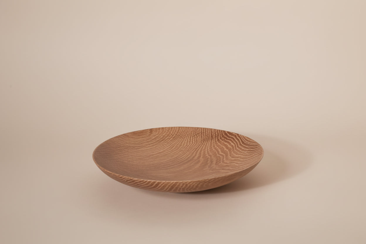 Wooden bowl with textured surface on a white background