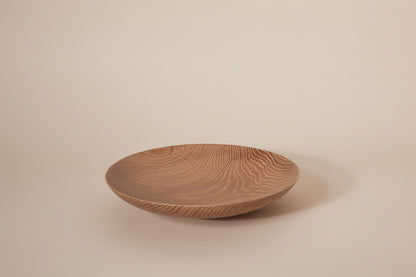Wooden bowl with textured surface on a white background