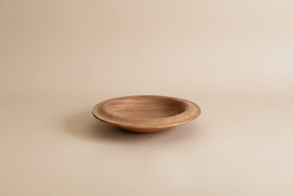 Wooden plate on a light gray background