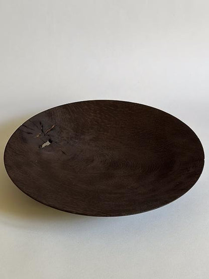 Dark wooden bowl on a light gray background