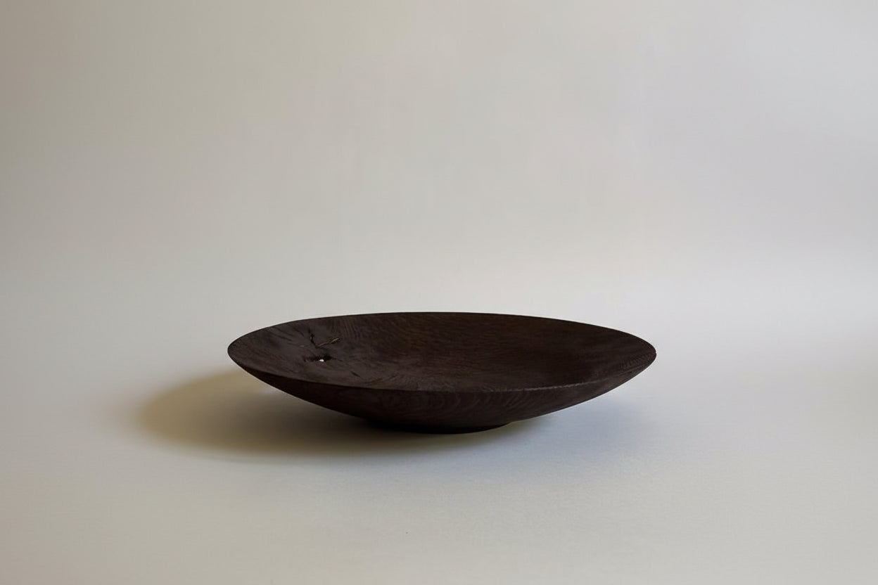 Dark wooden bowl on a light gray background