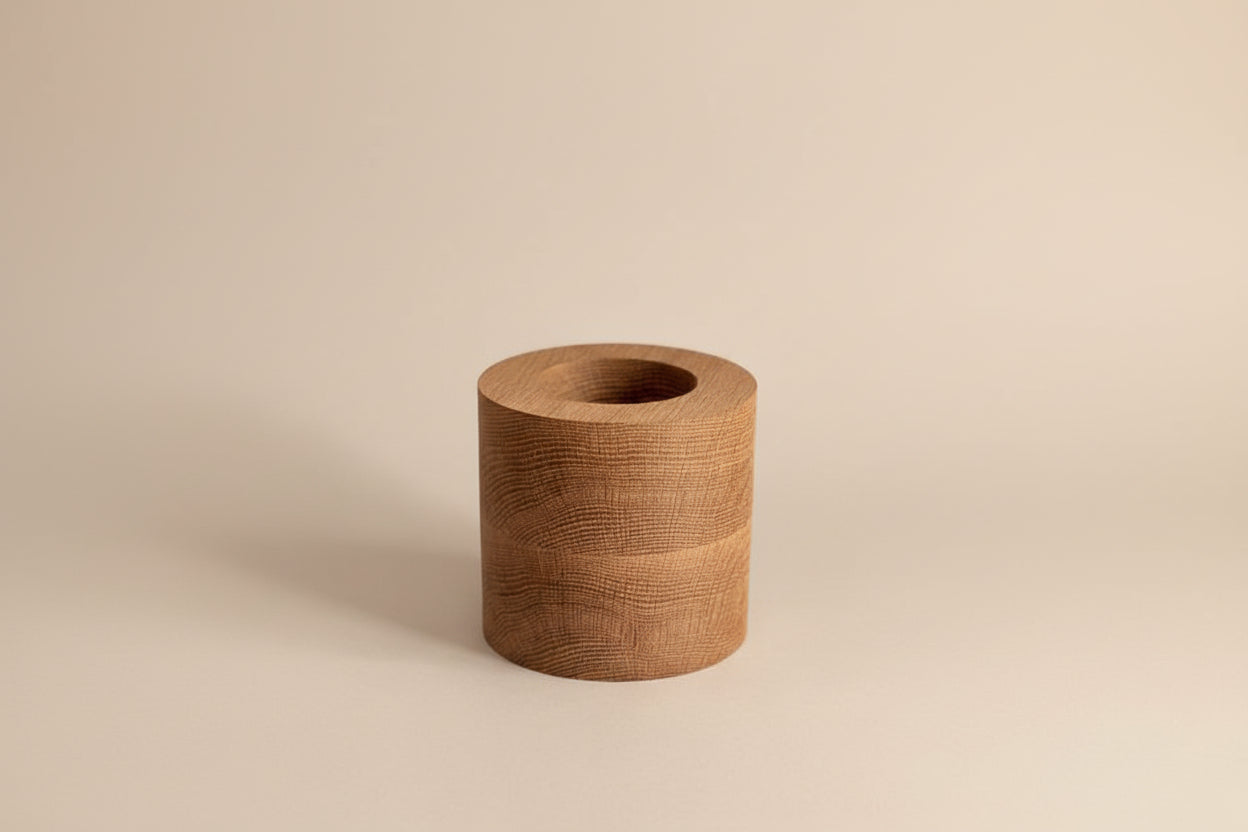 Wooden cylindrical object on a light gray background