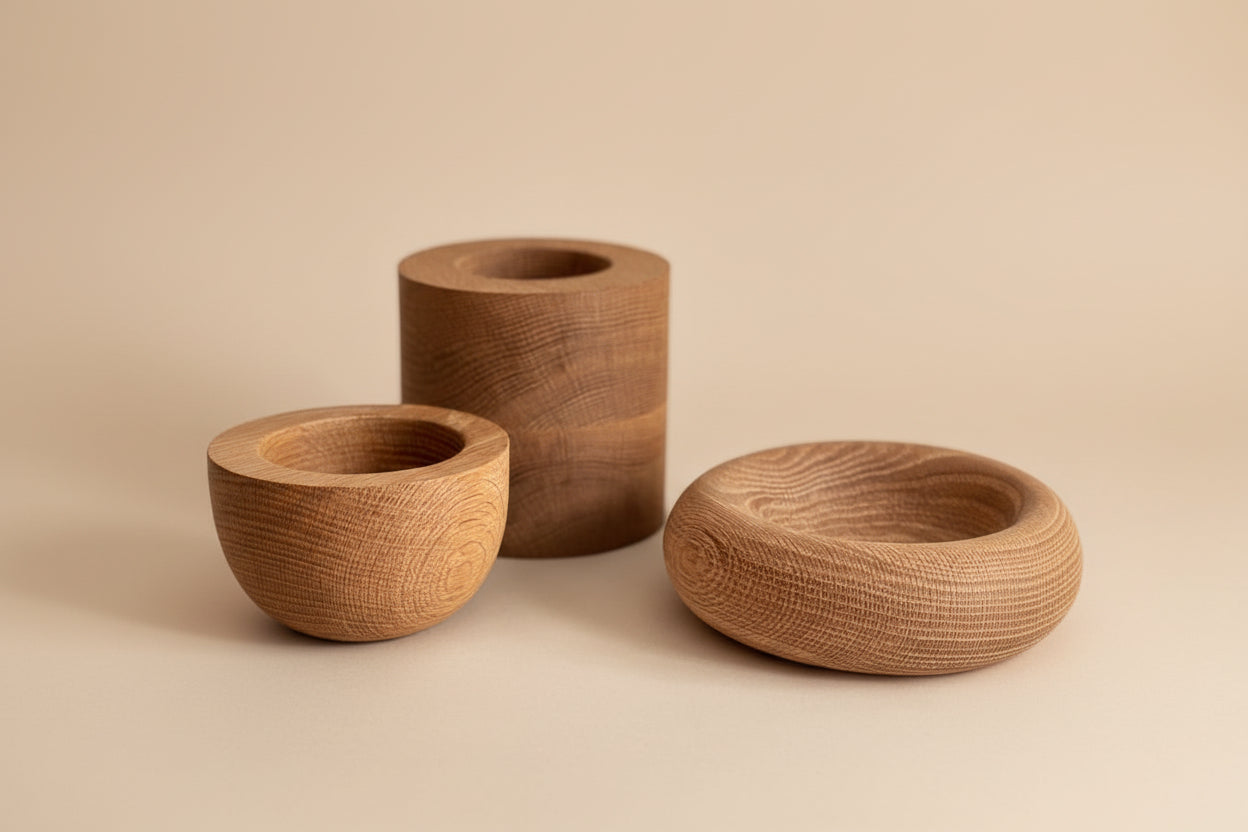 Three wooden bowls of different shapes and sizes on a light background