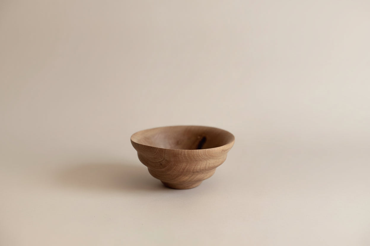 Wooden bowl on a beige background