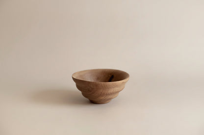 Wooden bowl on a beige background