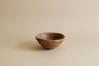 Wooden bowl on a light gray background