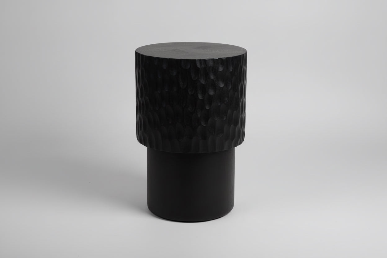 Wooden stool with textured surface on a wooden floor