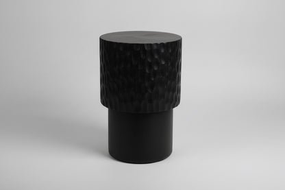 Wooden stool with textured surface on a wooden floor